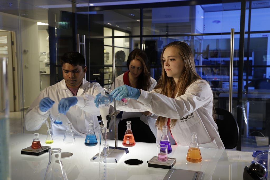 Three scientists conducting an experiment